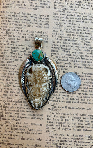 Western buffalo pendant featuring a carved water buffalo bone buffalo, genuine turquoise stone, and detailed silver-tone setting.