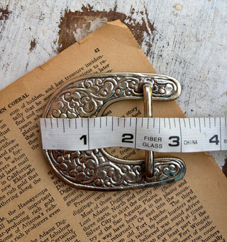 Western alloy belt buckle featuring authentic turquoise stones in assorted shapes and natural color variations