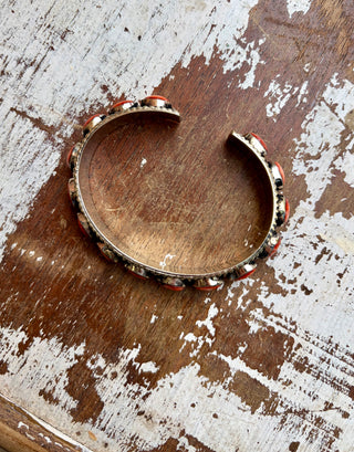 Red spiny oyster stone cuff bracelet set in alloy with seven oval stones and an antiqued finish.
