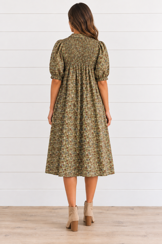 Back view mockup of a model wearing a green ditsy floral babydoll midi dress.