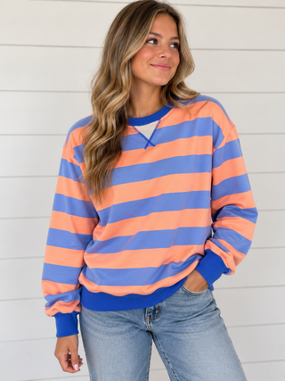 Sunday Drive peach and periwinkle blue striped sweatshirt with royal blue trim on model