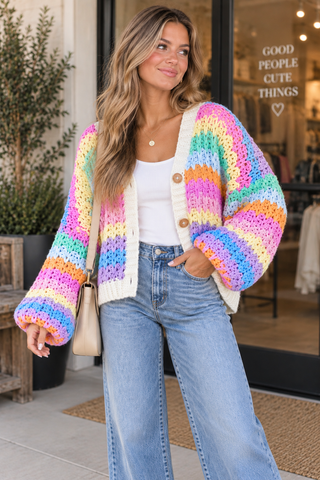 Happy Days colorful chunky knit cardigan with pastel rainbow stripes, cream trim and button-front detail.