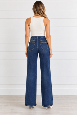 Back view of Risen dark blue high-rise wide leg jeans showing patch pockets and finished hems.
