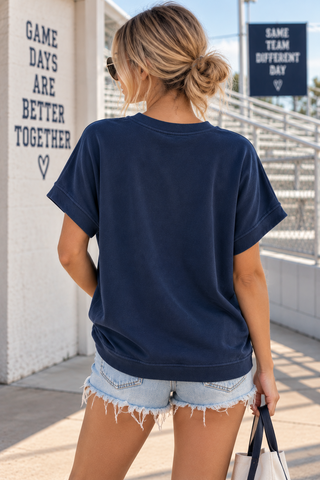 Model wearing navy Gameday oversized short sleeve sweatshirt tee with white varsity lettering