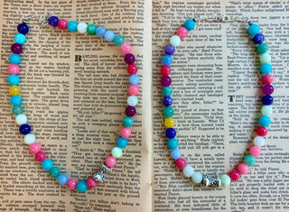 Handcrafted necklace featuring genuine pastel jade gemstone beads in shades of blue, turquoise, pink, purple, white, and yellow, finished with a sterling silver barrel bead centerpiece. A colorful gemstone necklace with a western-inspired style, perfect for everyday wear or layering.