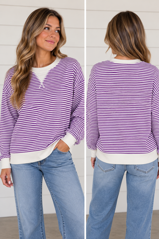 Woman wearing Purple Haze violet and white striped sweatshirt with white trim and light wash jeans