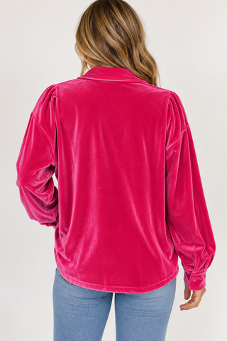 Model wearing Pink After Midnight hot pink velvet button-down top with light wash jeans