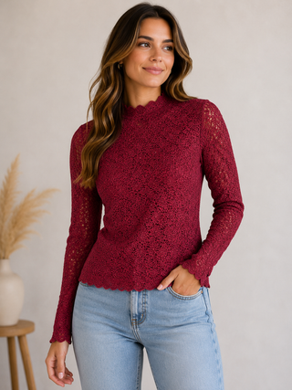 Model wearing the After Hours burgundy floral lace long sleeve top with light wash jeans.