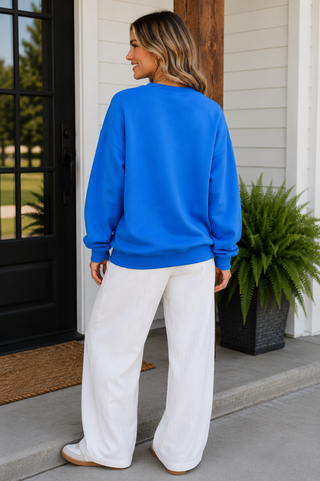 Blue Lucky Duck graphic sweatshirt with flying mallard ducks on model