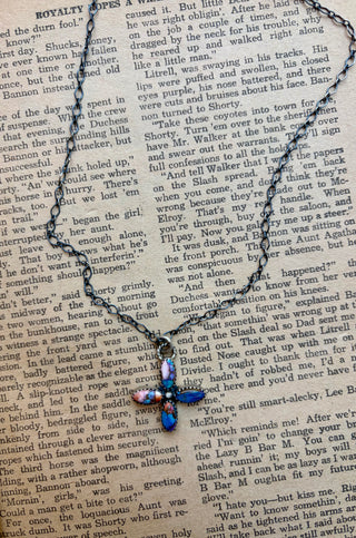 Handmade sterling silver cross necklace featuring pink dhalia and turquoise stones in a Southwestern design.
