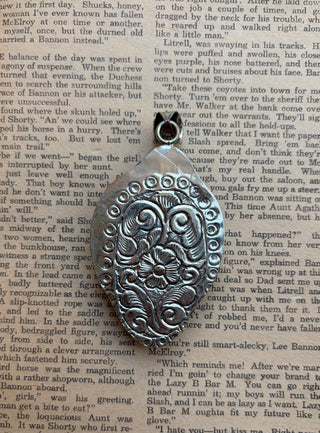 Western buffalo pendant featuring a carved water buffalo bone buffalo, genuine turquoise stone, and detailed silver-tone setting.