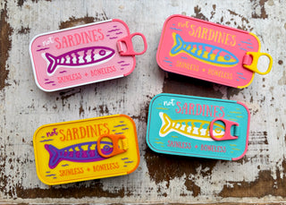 Colorful sardine tin travel jewelry organizers in assorted colors