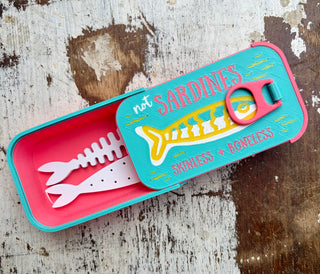 Sardine tin travel jewelry organizer open with removable fish-shaped jewelry holders