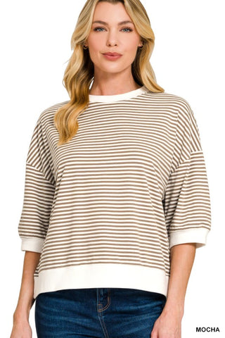 Women’s brown and white striped oversized knit top with a crew neckline, drop shoulders, elbow-length sleeves, and white ribbed trim at the neckline, cuffs, and hem. Relaxed fit with a modern casual style.