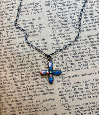 Handmade sterling silver cross necklace featuring pink and turquoise stones in a Southwestern design. 