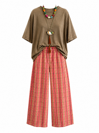 A styled outfit featuring an oversized brown short-sleeve t-shirt, red and brown plaid barrel pants, and a colorful beaded necklace, displayed on a clean white background.