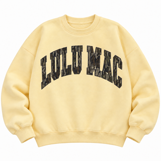 Butter yellow Lulu Mac crewneck sweatshirt with oversized Mossy Oak Bottomland camo lettering across the front.
