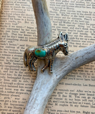 Western donkey pendant featuring a turquoise stone accent with detailed engraved metalwork.