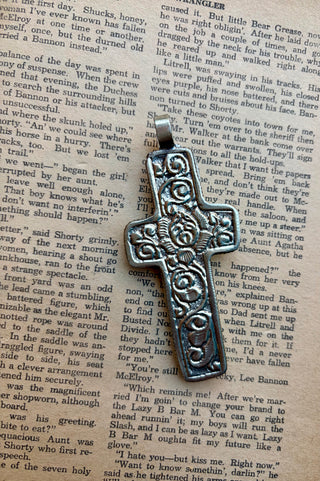 Alloy cross pendant featuring water buffalo bone and a round turquoise center stone with Western detailing.