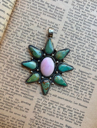 Pink conch and turquoise pendant featuring an oval pink conch center surrounded by teardrop turquoise stones with detailed Western-style metalwork.