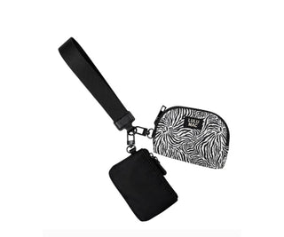Lulu Mac black and white zebra print wristlet with a black wrist strap and coordinating black zippered pouch.