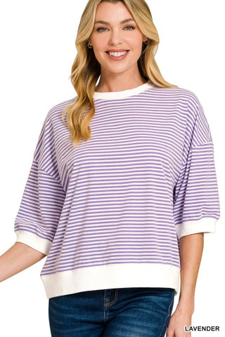 Women’s lavender and white striped oversized knit top with a crew neckline, drop shoulders, elbow-length sleeves, and white ribbed trim at the neckline, cuffs, and hem. Relaxed fit with a modern casual style.